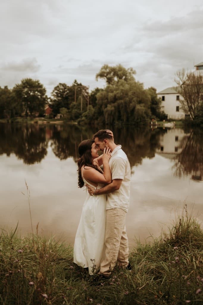 Jaz and Michael in an intimate embrace outdoors by the water