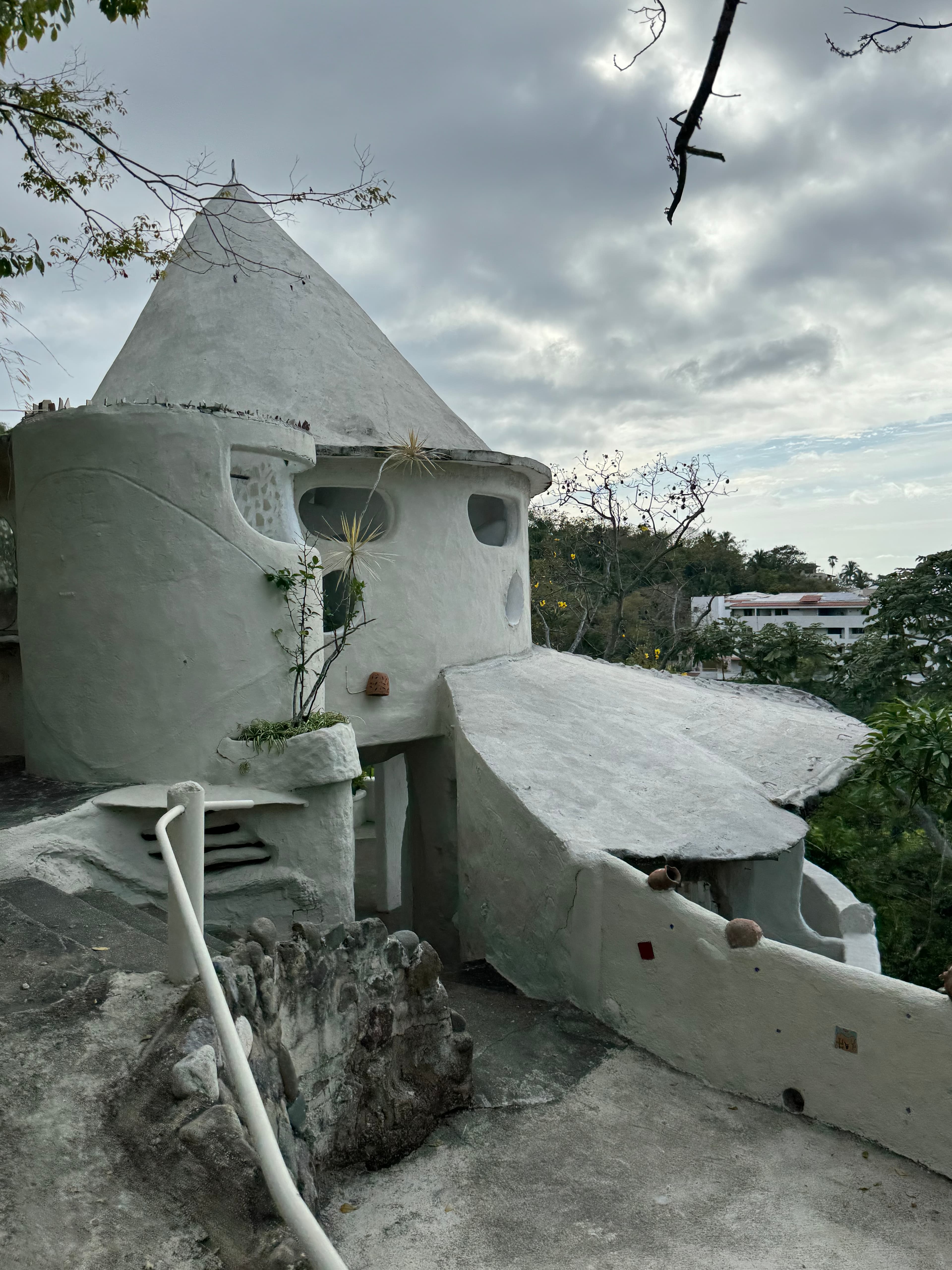 White dome temazcal structure nestled in tropical greenery